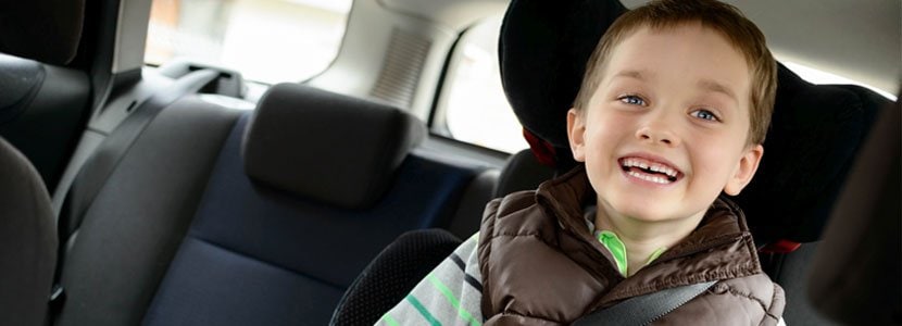 Child smiling in his car seat