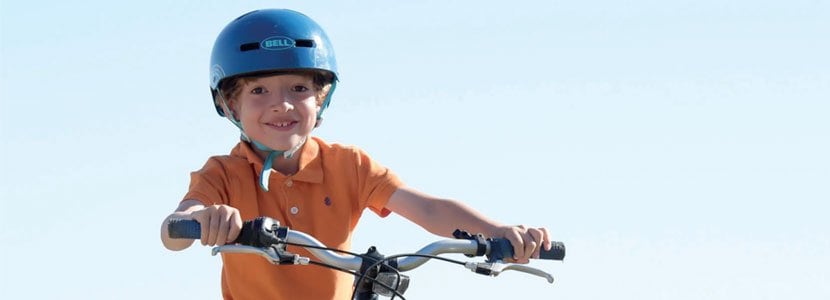 Boy smiling on a bicycle