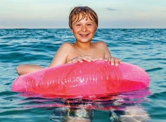 Child on inflatable floating in the ocean