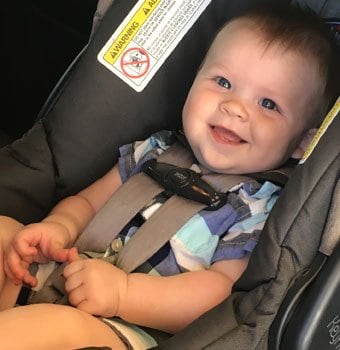 Smiling child in a car seat