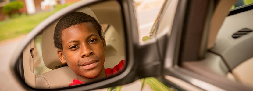 Teen driver sitting in a car