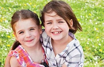 two children embracing and smiling